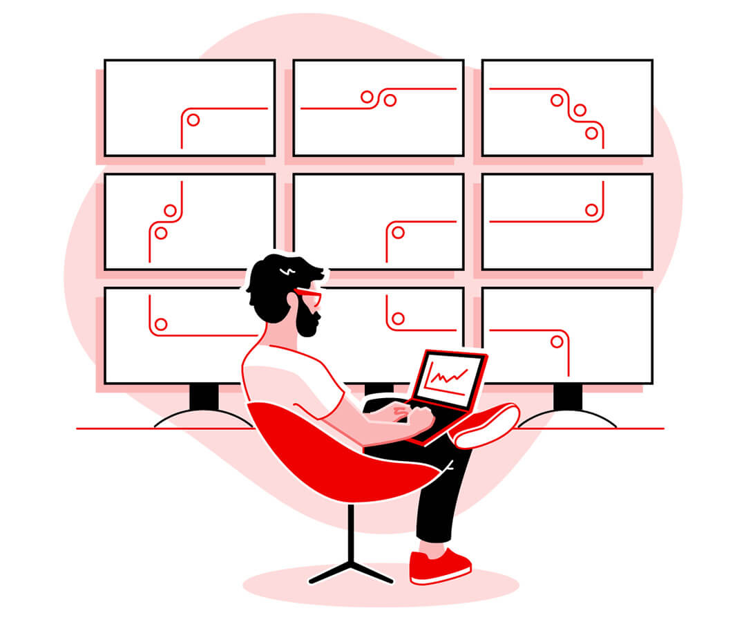 Person casually sitting in red chair working from desktop with 9 monitors connecting in backdrop