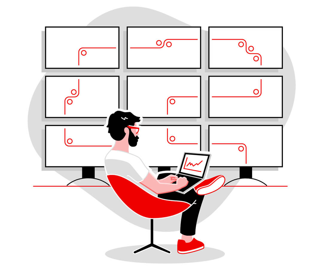 Persona sentada de manera relajada en una silla roja trabajando en un escritorio con nueve monitores conectados al fondo.