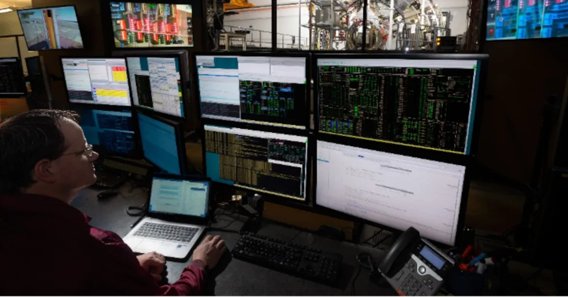 Person sitting in front of monitors